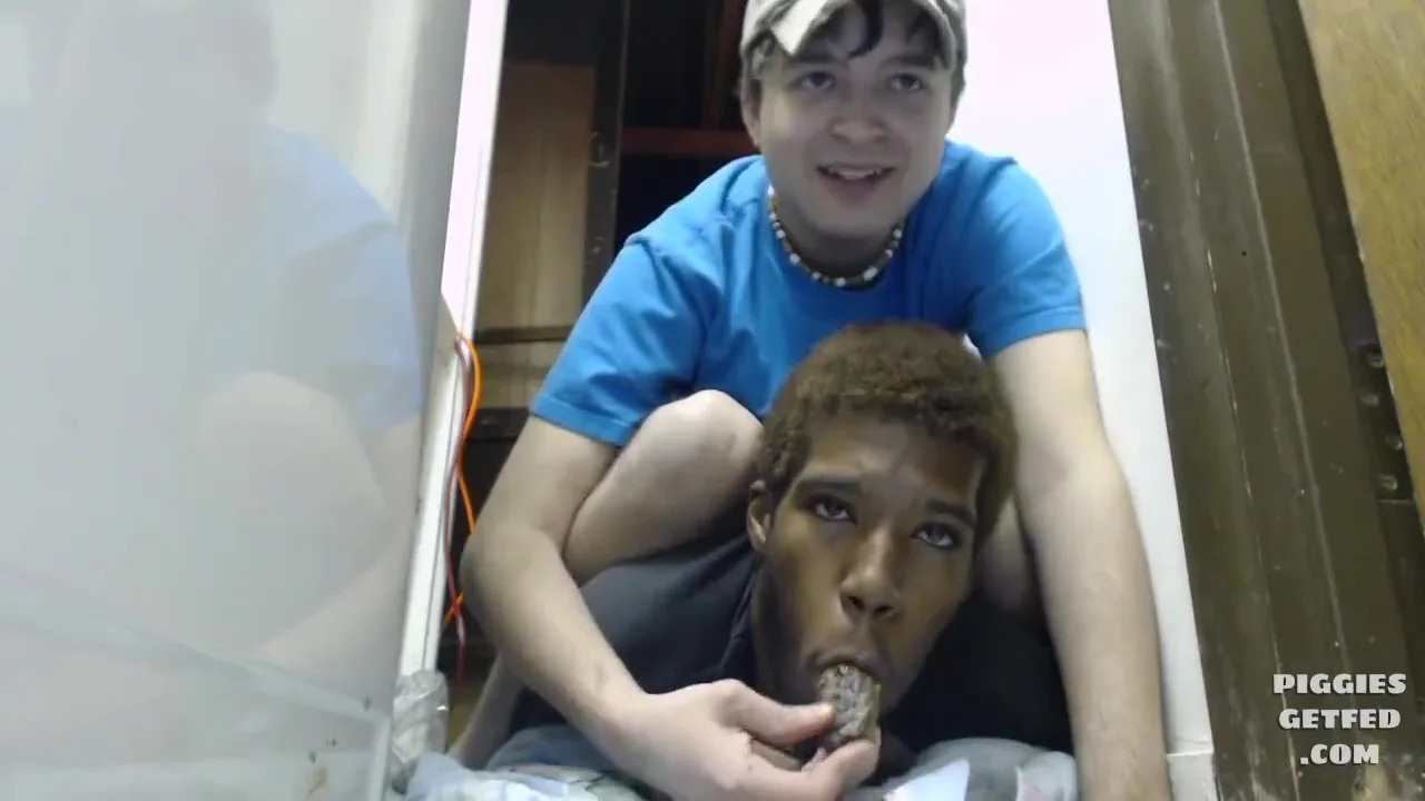 Feeder smokes while feeding his pig a log