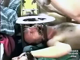 Tied down, mouth gagged, and fed